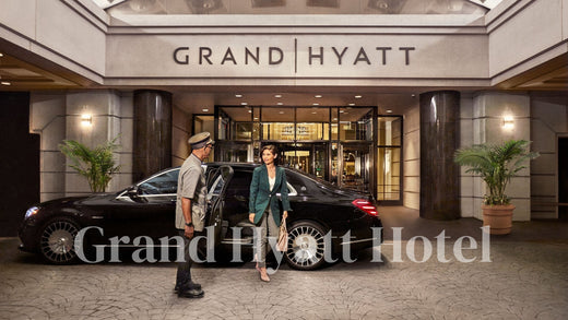 a lady just off the car and talking with the security before the grand hyatt hotel.