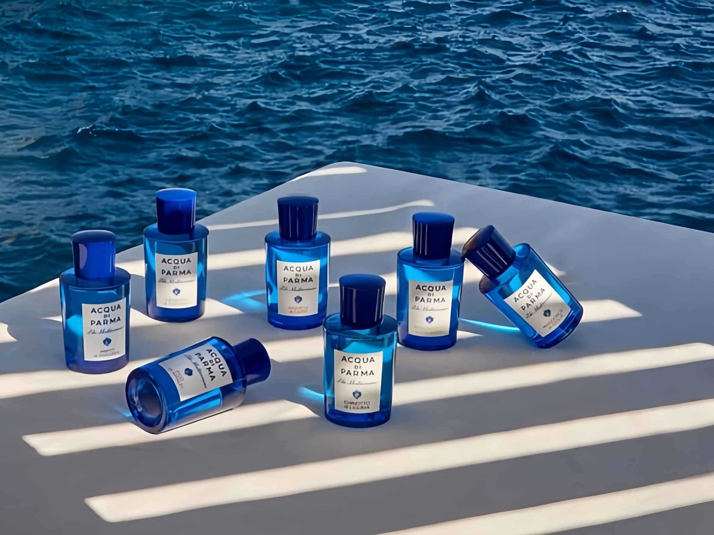 With the sea as the background, 7 bottles of acqua di parma are displayed, highlighting the Mediterranean theme